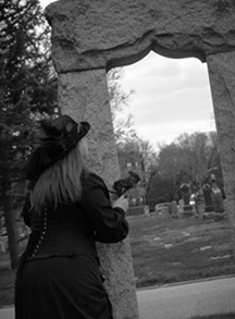 Woman with her back turned looking toward a cemetery